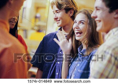 Two teenage girls and three teenage boys talking to each other View Large Photo Image Stock Photo - Two teenage girls and three teenage boys talking to each other. Fotosearch