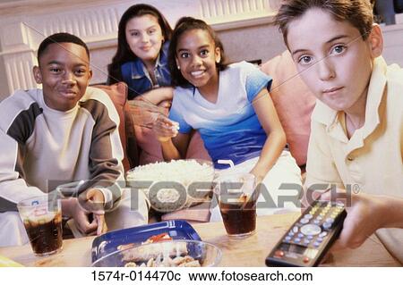 Two teenage girls and two teenage boys watching television View Large Photo Image Stock Image - Two teenage girls and two teenage boys watching television. Fotosearch