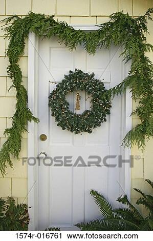 Stock Image - Wreath hanging on a door. Fotosearch