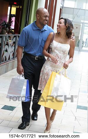 Young couple carrying shopping bags View Large Photo Image Stock Image - Young couple carrying shopping bags. Fotosearch