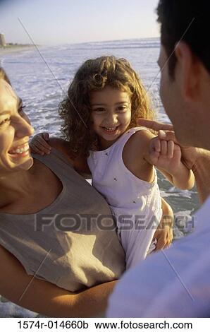 Young couple on the beach with their daughter View Large Photo Image Stock Image - Young couple on the beach with their daughter. Fotosearch