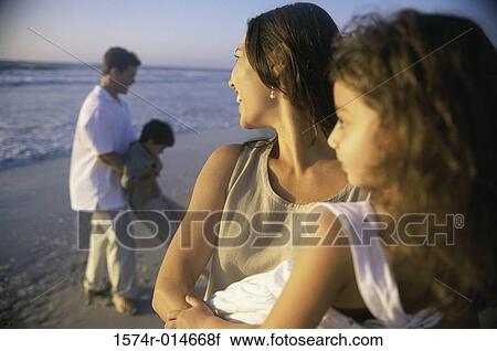 Young couple on the beach with their son and daughter View Large Photo Image Stock Image - Young couple on the beach with their son and daughter. Fotosearch