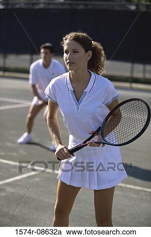Stock Image - Young couple playing tennis. Fotosearch