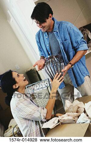 Young couple unpacking in their new house View Large Photo Image Stock Photo - Young couple unpacking in their new house. Fotosearch