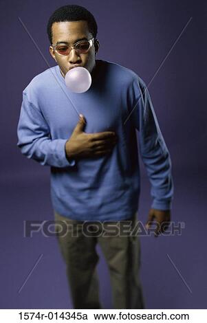 Young man blowing a bubble View Large Photo Image Stock Image - Young man blowing a bubble. Fotosearch