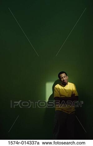 Young man standing with his arms crossed View Large Photo Image Stock Image - Young man standing with his arms crossed. Fotosearch