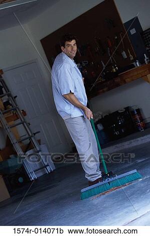 Young man sweeping the floor with a broom View Large Photo Image Stock Image - Young man sweeping the floor with a broom. Fotosearch