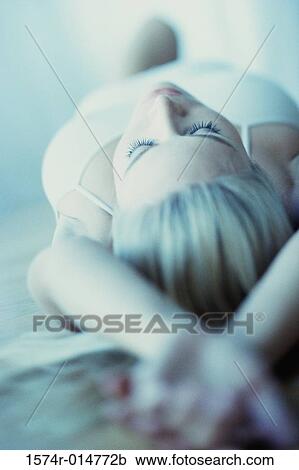 Young woman lying on back View Large Photo Image Stock Image - Young woman lying on back. Fotosearch