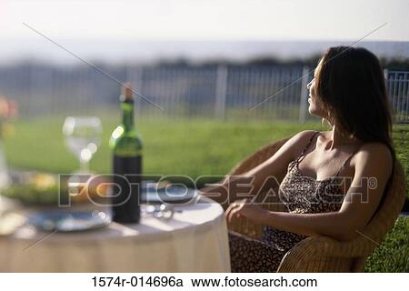 Young woman sitting in a chair on a lawn View Large Photo Image Stock Image - Young woman sitting in a chair on a lawn. Fotosearch