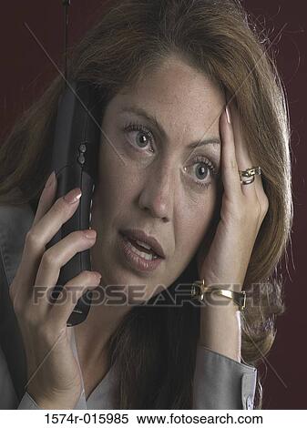 Young woman talking on a mobile phone View Large Photo Image Stock Photography - Young woman talking on a mobile phone. Fotosearch
