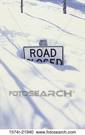A road closed sign buried in snow View Large Photo Image Stock Image - A road closed sign buried in snow. Fotosearch