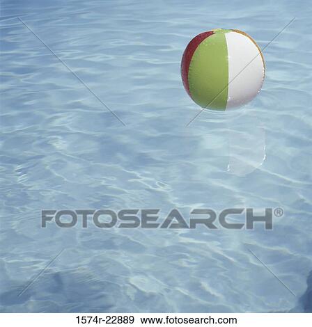 Beach ball in a swimming pool View Large Photo Image Stock Photo - Beach ball in a swimming pool. Fotosearch