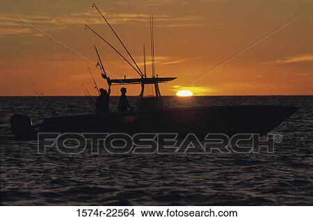 Boat with the sunset in the background View Large Photo Image Picture - Boat with the sunset in the background. Fotosearch