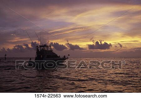 Boat with the sunset in the background View Large Photo Image Stock Image - Boat with the sunset in the background. Fotosearch
