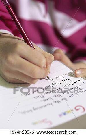 Close-up of a child writing with a pencil on paper View Large Photo Image Stock Photography - Close-up of a child writing with a pencil on paper. Fotosearch