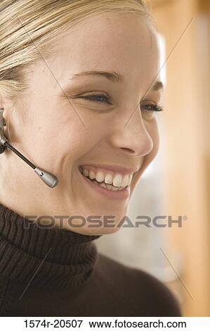 Close-up of a female customer service representative wearing a headset View Large Photo Image Stock Photo - Close-up of a female customer service representative wearing a headset. Fotosearch