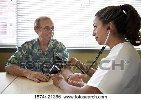Stock Photograph - Close-up of a female doctor examining a patient. Fotosearch
