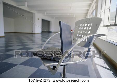 Close-up of a laptop in a chair View Large Photo Image Stock Image - Close-up of a laptop in a chair. Fotosearch