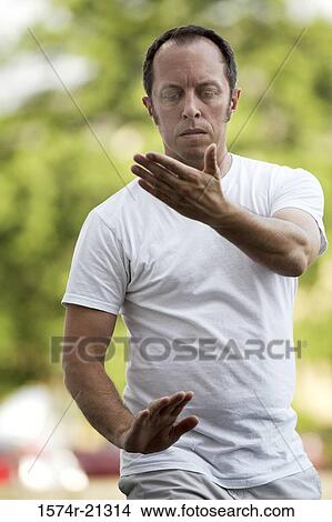 Picture - Close-up of a mature man practicing tai chi. Fotosearch