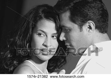Stock Image - Close-up of a mid adult couple being romantic. Fotosearch