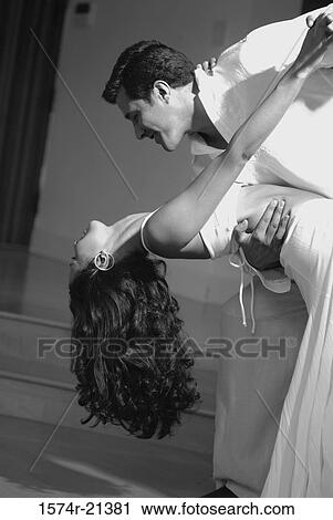 Stock Image - Close-up of a mid adult couple dancing the tango. Fotosearch