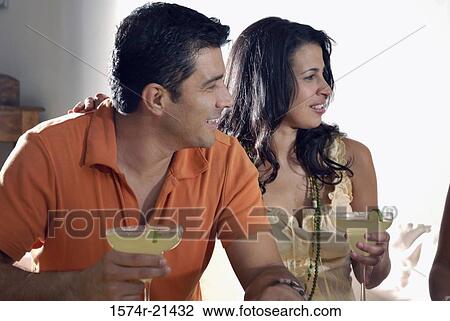 Close-up of a mid adult couple holding margaritas View Large Photo Image Stock Image - Close-up of a mid adult couple holding margaritas. Fotosearch