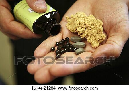Close-up of a person holding medicine in his palm View Large Photo Image Picture - Close-up of a person holding medicine in his palm. Fotosearch