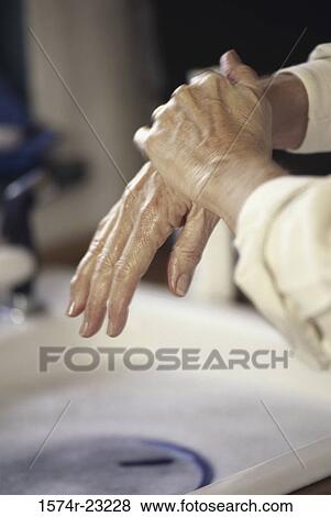 Stock Photo - Close-up of a person rubbing their hands. Fotosearch
