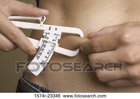 Close-up of a person using a skin fold caliper View Large Photo Image Stock Photograph - Close-up of a person using a skin fold caliper. Fotosearch