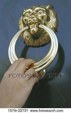 Close-up of a person's hand using a doorknocker View Large Photo Image Stock Image - Close-up of a person's hand using a doorknocker. Fotosearch
