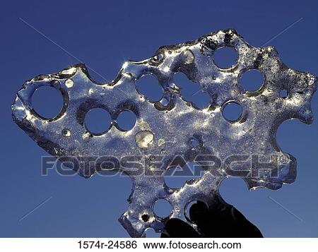 Close-up of a piece of ice with holes View Large Photo Image Stock Photograph - Close-up of a piece of ice with holes. Fotosearch