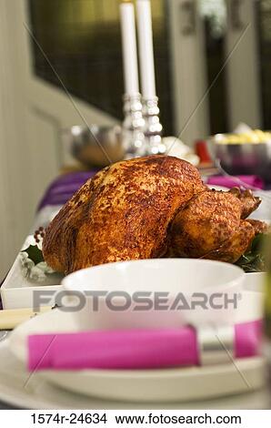Close-up of a roasted turkey with candles on a table View Large Photo Image Picture - Close-up of a roasted turkey with candles on a table. Fotosearch