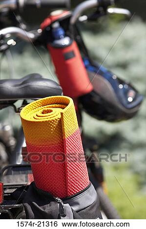 Close-up of a rolled up mat hanging on a bicycle View Large Photo Image Stock Photograph - Close-up of a rolled up mat hanging on a bicycle. Fotosearch