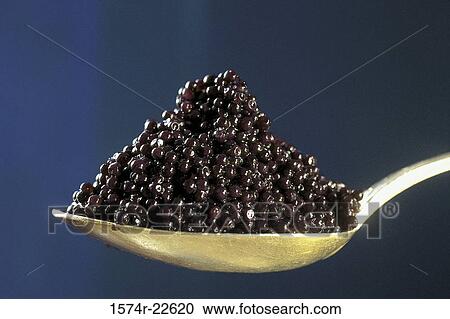 Stock Image - Close-up of a spoon full of caviar. Fotosearch