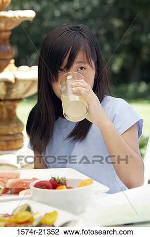 Close-up of a teenage girl drinking lemonade View Large Photo Image Stock Image - Close-up of a teenage girl drinking lemonade. Fotosearch