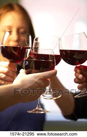 Close-up of a woman and three people toasting with wine glasses View Large Photo Image Stock Photography - Close-up of a woman and three people toasting with wine glasses. Fotosearch