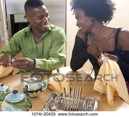 Close-up of a young couple drying dishes View Large Photo Image Stock Photography - Close-up of a young couple drying dishes. Fotosearch