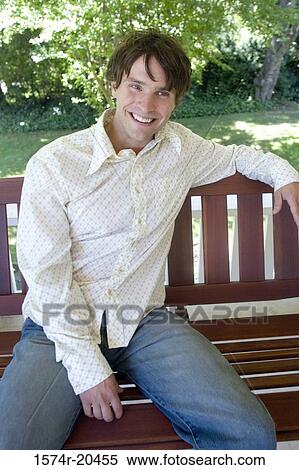 Close-up of a young man sitting on a porch swing View Large Photo Image Stock Photography - Close-up of a young man sitting on a porch swing. Fotosearch