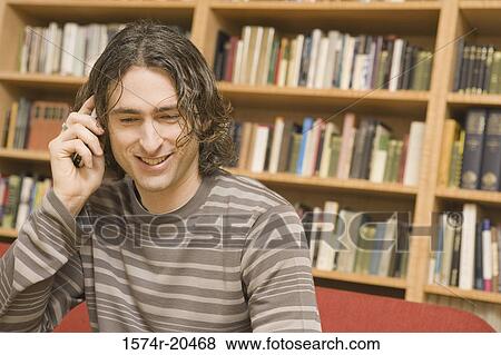 Close-up of a young man talking on a mobile phone View Large Photo Image Stock Photo - Close-up of a young man talking on a mobile phone. Fotosearch