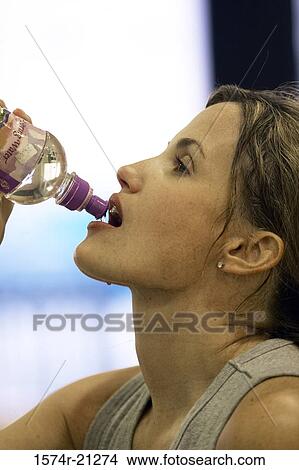 Close-up of a young woman drinking water View Large Photo Image Picture - Close-up of a young woman drinking water. Fotosearch