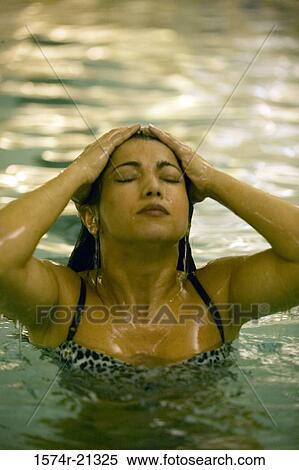 Close-up of a young woman in a swimming pool View Large Photo Image Stock Photography - Close-up of a young woman in a swimming pool. Fotosearch