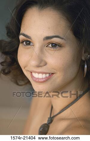 Close-up of a young woman smiling View Large Photo Image Picture - Close-up of a young woman smiling. Fotosearch