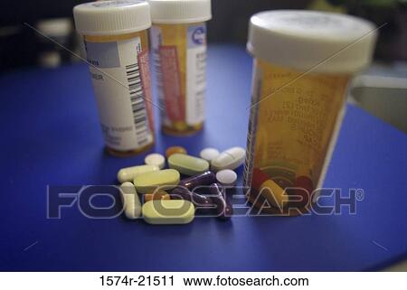 Close-up of capsules and tablets near three vials View Large Photo Image Stock Image - Close-up of capsules and tablets near three vials. Fotosearch