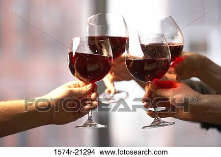 Close-up of four people's hands toasting with wine glasses View Large Photo Image Picture - Close-up of four people's hands toasting with wine glasses. Fotosearch