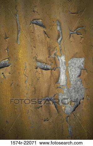Stock Image - Close-up of paint peeling off a metal surface. Fotosearch