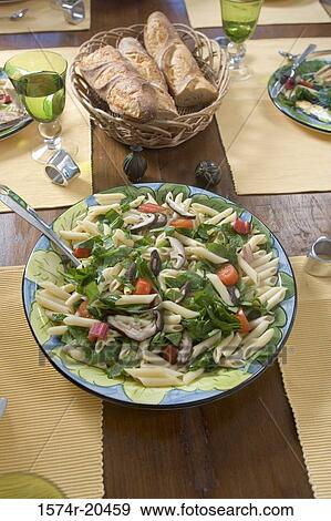 Close-up of pasta and loaves of bread on a dining table View Large Photo Image Stock Photo - Close-up of pasta and loaves of bread on a dining table. Fotosearch
