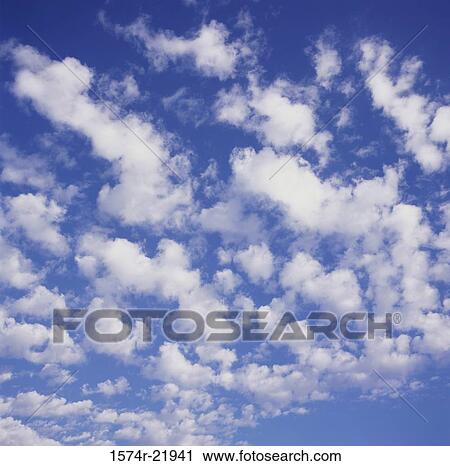 Clouds in a blue sky View Large Photo Image Stock Image - Clouds in a blue sky. Fotosearch