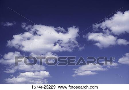 Clouds in a blue sky View Large Photo Image Stock Photo - Clouds in a blue sky. Fotosearch