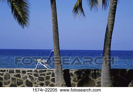 Deck chair on a wall at the beach, Hawaii, USA View Large Photo Image Stock Photography - Deck chair on a wall at the beach, Hawaii, USA. Fotosearch