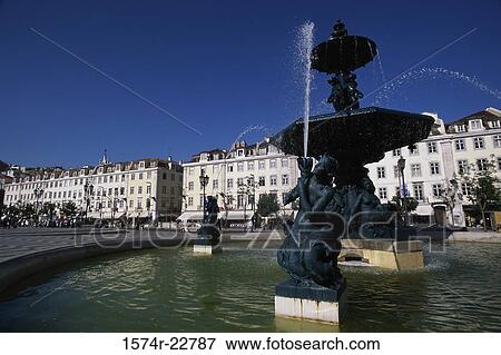 Fountain in front of buildings, Rossio Square, Lisbon, Portugal View Large Photo Image Stock Photo - Fountain in front of buildings, Rossio Square, Lisbon, Portugal. Fotosearch
